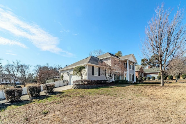 view of front of house with a front yard and a garage