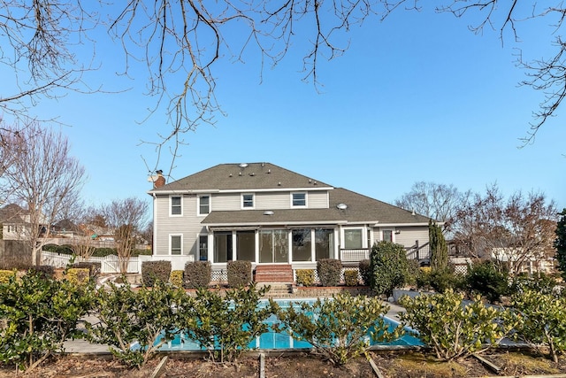 back of house featuring a sunroom