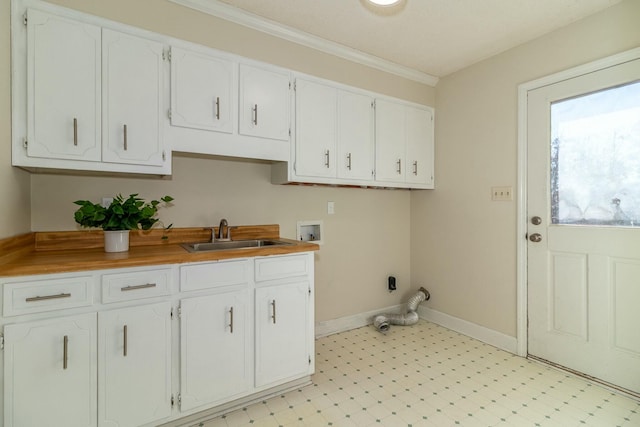 clothes washing area featuring washer hookup, sink, and cabinets