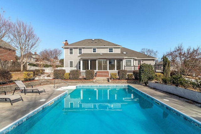 back of house with a patio area and a sunroom