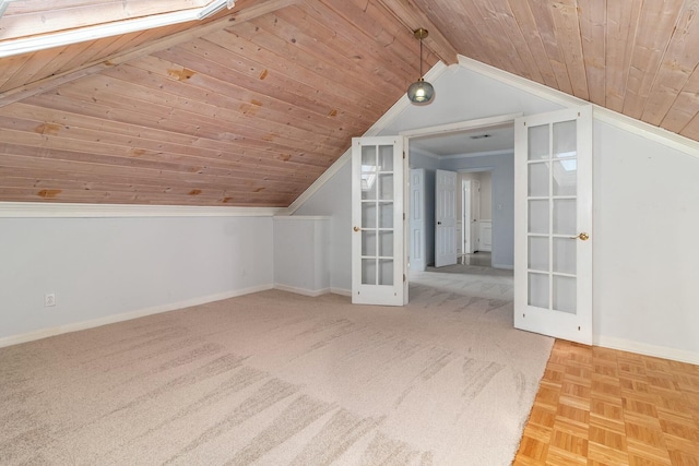 bonus room featuring wooden ceiling, vaulted ceiling with skylight, and french doors