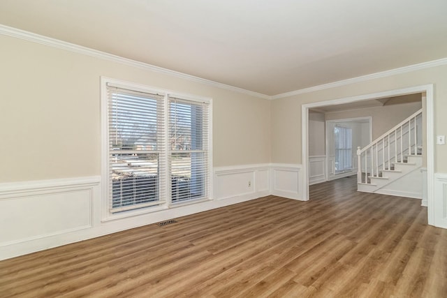 spare room with ornamental molding and hardwood / wood-style flooring