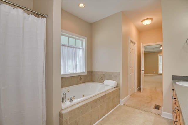 116 Barrett Mill Rd, Waynesboro, GA 30830 - full bathroom featuring vanity, a whirlpool tub, healthy amount of natural light, and a shower with shower curtain