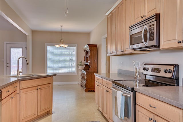 116 Barrett Mill Rd, Waynesboro, GA 30830 - kitchen with appliances with stainless steel finishes, light brown cabinets, and hanging light fixtures