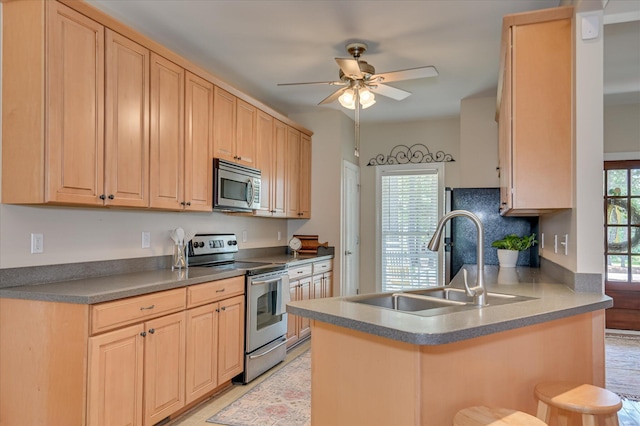 116 Barrett Mill Rd, Waynesboro, GA 30830 - kitchen featuring appliances with stainless steel finishes, a ceiling fan, a peninsula, and light brown cabinetry