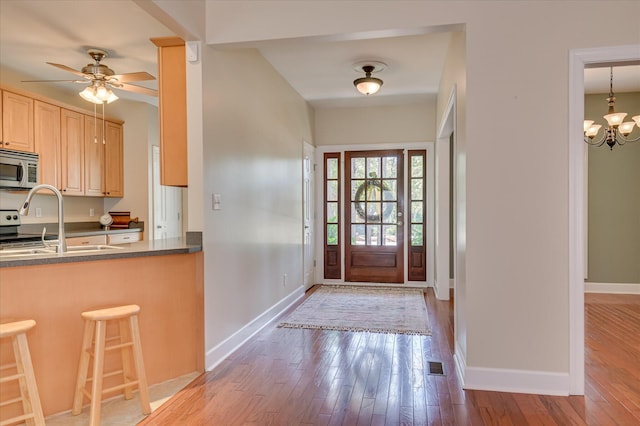 116 Barrett Mill Rd, Waynesboro, GA 30830 - foyer with wood-type flooring, a chandelier, and a ceiling fan