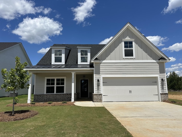 craftsman-style home with concrete driveway, a standing seam roof, brick siding, and a front yard