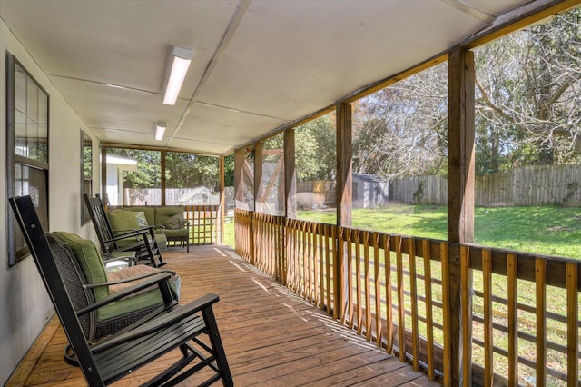 wooden terrace with a lawn and a fenced backyard