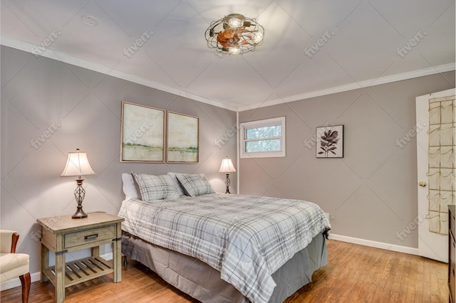 bedroom featuring light wood finished floors, baseboards, and ornamental molding