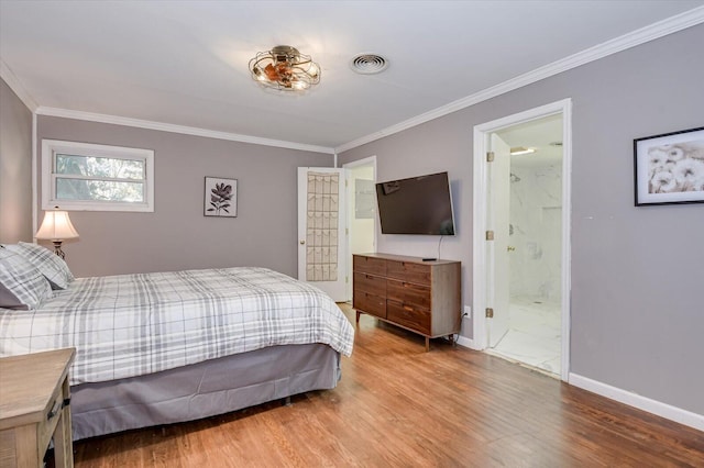 bedroom with ornamental molding, baseboards, and wood finished floors