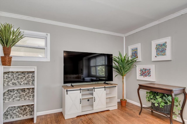 living room with crown molding, light wood-style floors, and baseboards