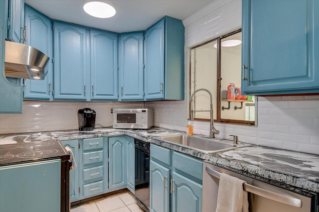 kitchen with blue cabinetry, range hood, stainless steel dishwasher, a sink, and light tile patterned flooring