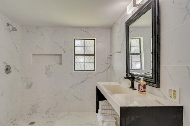 full bathroom featuring tile walls, marble finish floor, a marble finish shower, and vanity
