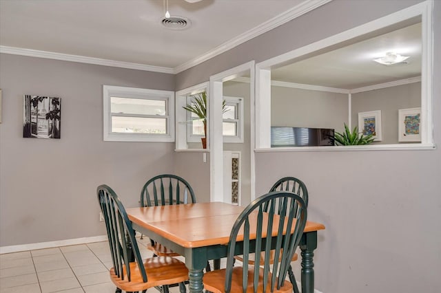 dining area featuring tile patterned floors, crown molding, baseboards, and visible vents