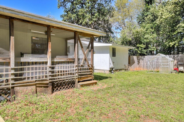 view of yard with an outbuilding and fence