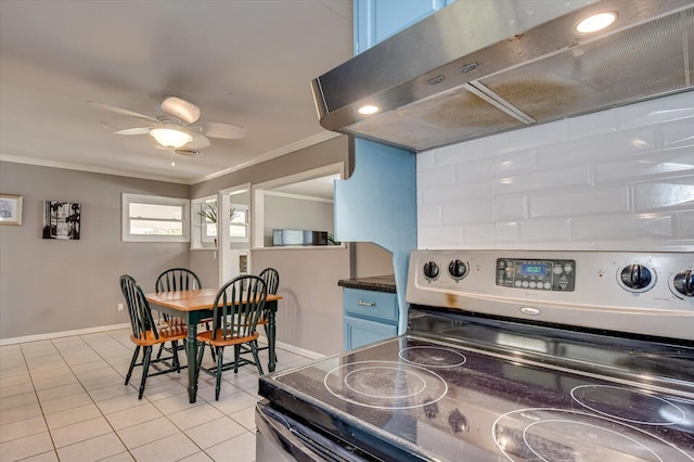 kitchen with stainless steel electric range oven, ornamental molding, under cabinet range hood, blue cabinets, and light tile patterned floors