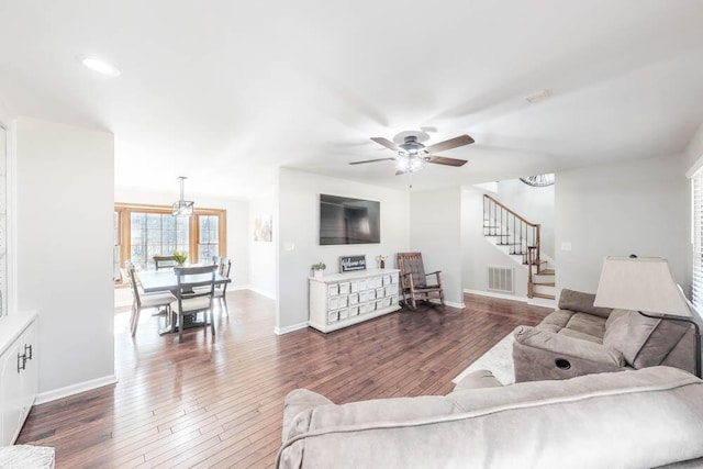 living room with dark wood-type flooring and ceiling fan