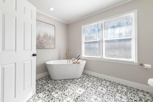 bathroom with toilet, tile patterned floors, and a tub to relax in