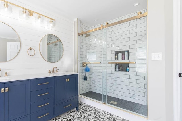 bathroom with an enclosed shower, vanity, and tile patterned flooring