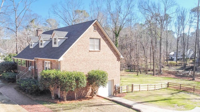 view of side of home with a garage and a lawn