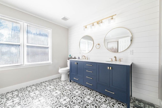 bathroom with vanity, plenty of natural light, tile patterned floors, and toilet