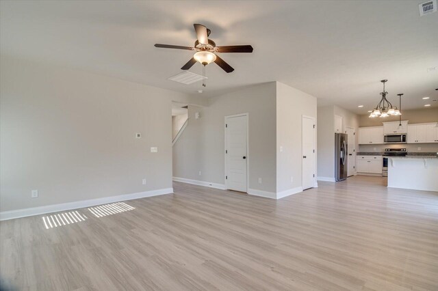 610 Turtle Crk Ln, Harlem, GA 30814 - unfurnished living room featuring a ceiling fan, baseboards, light wood finished floors, a chandelier, and recessed lighting