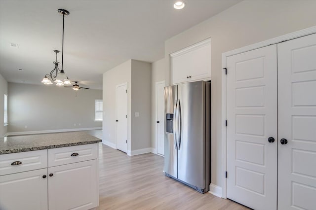 610 Turtle Crk Ln, Harlem, GA 30814 - kitchen featuring stainless steel fridge, white cabinets, decorative light fixtures, baseboards, and light wood-style floors
