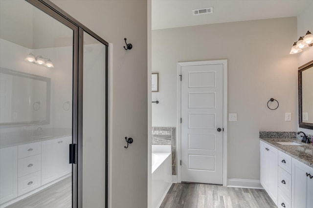 610 Turtle Crk Ln, Harlem, GA 30814 - bathroom featuring wood finished floors, a bath, vanity, and a stall shower