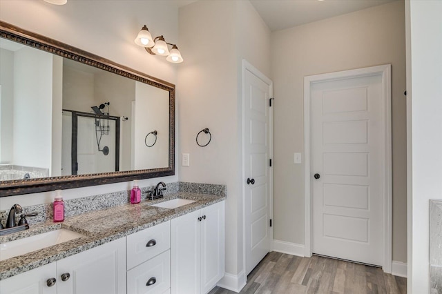 610 Turtle Crk Ln, Harlem, GA 30814 - bathroom with wood finished floors, a stall shower, double vanity, and baseboards