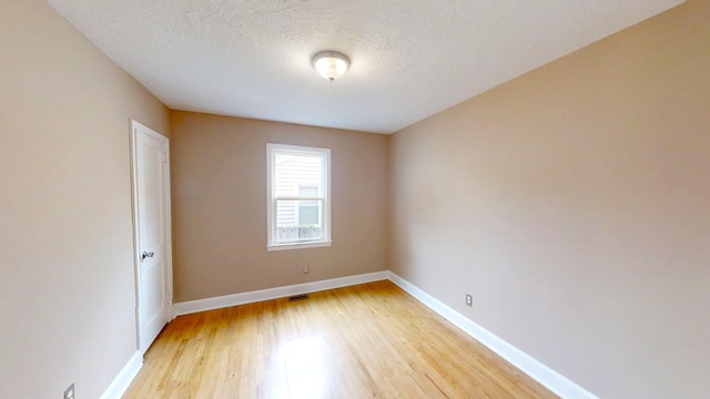 1443 Spring Hill Ter, Augusta, GA 30904 - spare room featuring a textured ceiling, baseboards, visible vents, and light wood finished floors