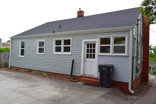 1443 Spring Hill Ter, Augusta, GA 30904 - rear view of property with entry steps, a chimney, and a shingled roof