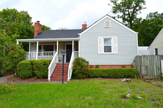 1443 Spring Hill Ter, Augusta, GA 30904 - view of front of property with covered porch, fence, a chimney, and a front lawn