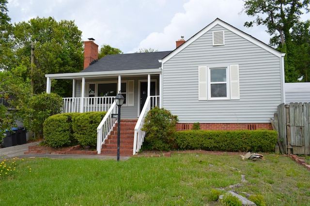 1443 Spring Hill Ter, Augusta, GA 30904 - view of front of home with fence, a front yard, a chimney, a porch, and stairway