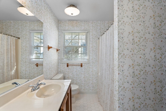 bathroom featuring toilet, wallpapered walls, tile patterned flooring, and vanity