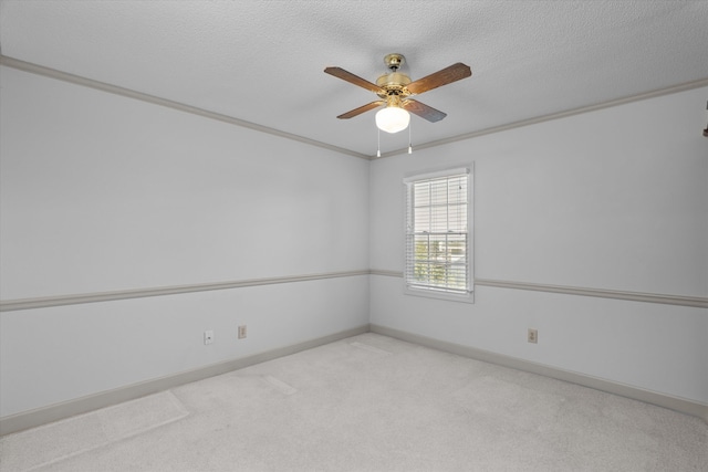 unfurnished room with light carpet, baseboards, a ceiling fan, ornamental molding, and a textured ceiling