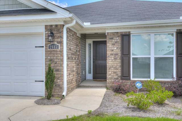 2613 Inverness Dr, Hephzibah, GA 30815 - doorway to property with a garage, roof with shingles, and brick siding