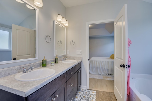 2613 Inverness Dr, Hephzibah, GA 30815 - bathroom with double vanity, a tub to relax in, tile patterned floors, and ensuite bathroom