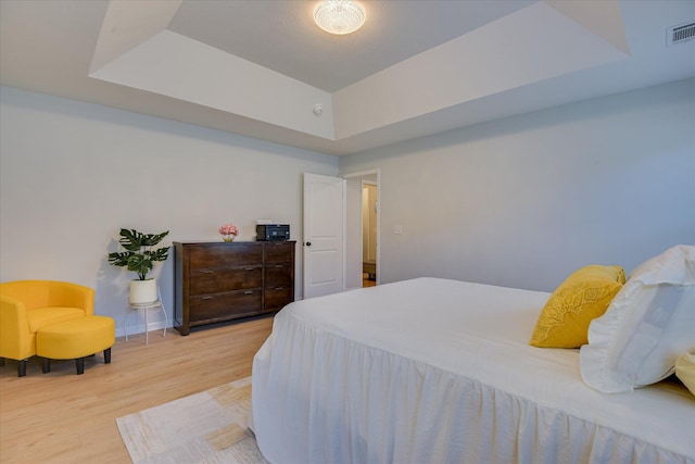 2613 Inverness Dr, Hephzibah, GA 30815 - bedroom with light wood finished floors and a tray ceiling