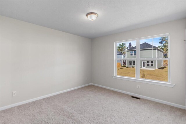 unfurnished room featuring carpet floors