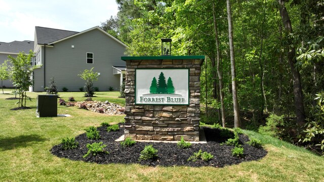 community / neighborhood sign with a lawn