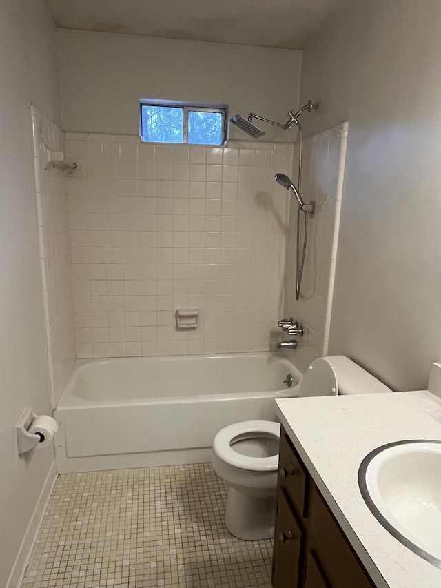 full bathroom with tile patterned floors, vanity, tiled shower / bath combo, and toilet