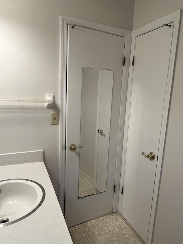 bathroom with tile patterned flooring and vanity