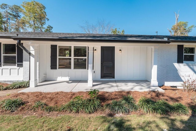 back of property featuring covered porch