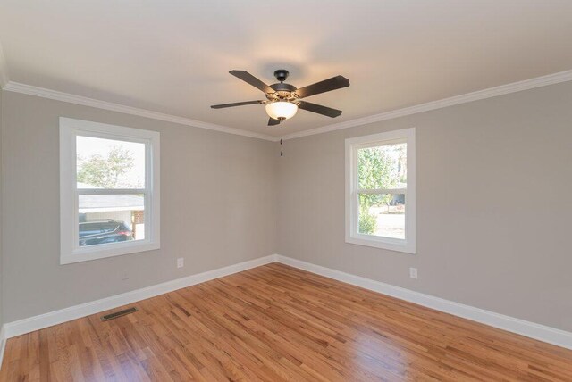 spare room featuring ceiling fan, light hardwood / wood-style floors, and crown molding