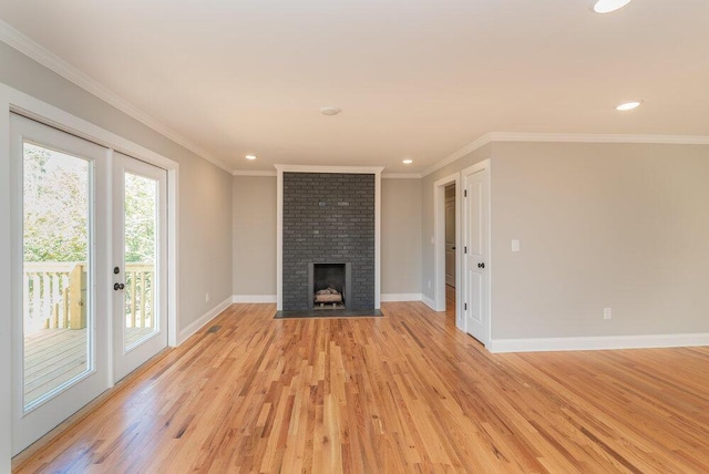 unfurnished living room featuring a fireplace, light wood-type flooring, and crown molding