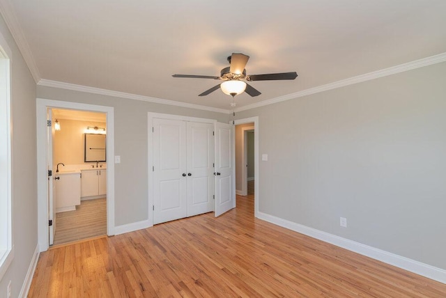 unfurnished bedroom with light wood-type flooring, ensuite bath, ceiling fan, and crown molding