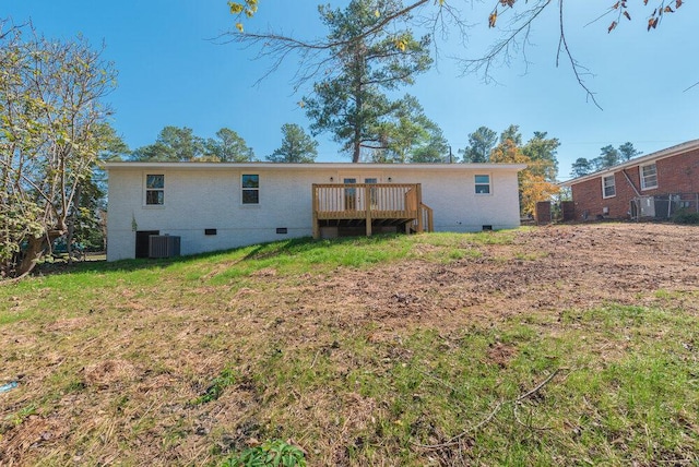 back of property featuring a lawn, central AC unit, and a deck