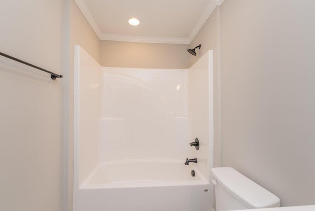 bathroom featuring crown molding, washtub / shower combination, and toilet