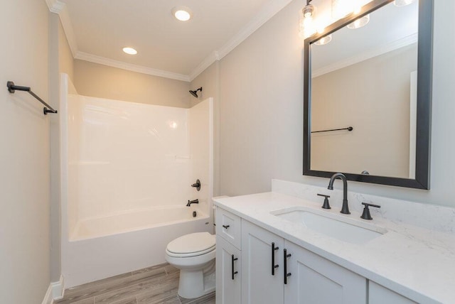 full bathroom with ornamental molding, vanity, shower / bathing tub combination, hardwood / wood-style floors, and toilet