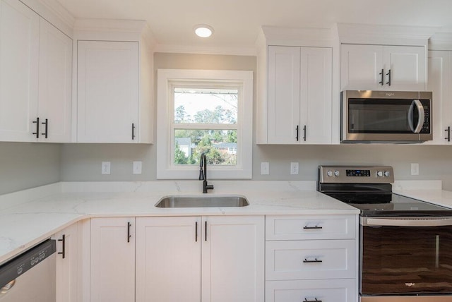 kitchen with white cabinetry, sink, and stainless steel appliances